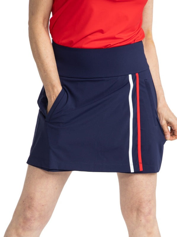 Front view of the Skort and Short Golf Skort in Navy Blue. This skort has two vertical stripes down the front left side in white and cherry red. 