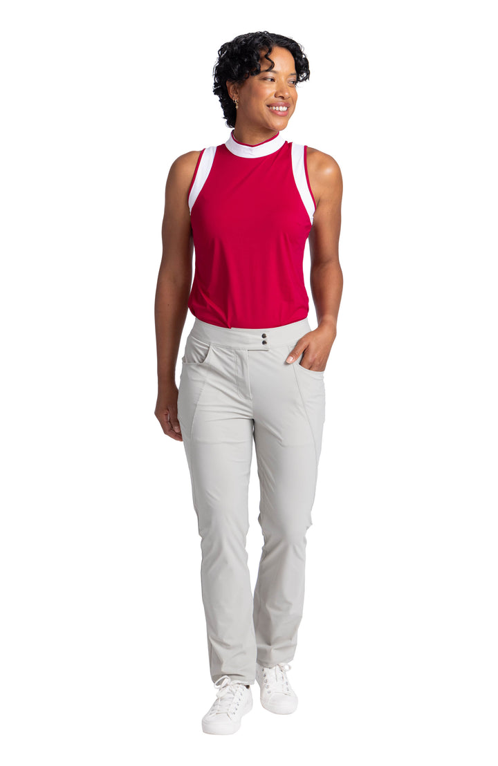 Full front view of a woman wearing the Knock Out top in Bordeaux Red and the Club Compliant pant in Neutral Sand. 