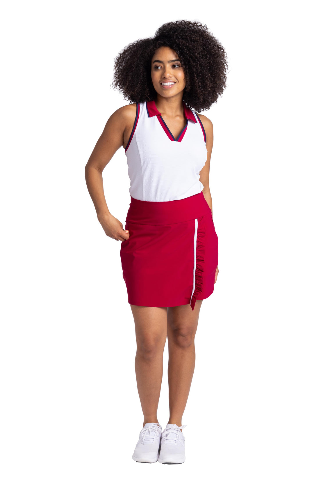 Full front view of a women wearing white racerback top with contrasting navy blue and Bordeaux red binding on the armholes and neckline; and a Bordeaux red collar. The top is paired with the Ruffle in the Rough Skort in Bordeaux Red.